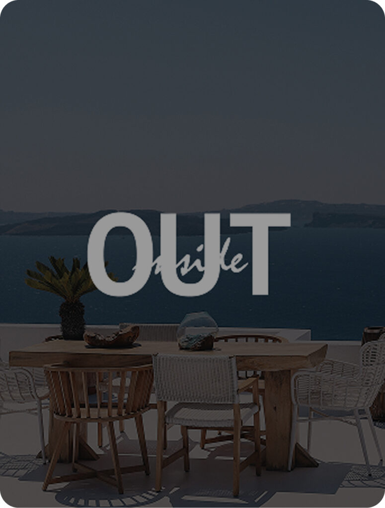 View to the ocean from a balcony with a dinner table