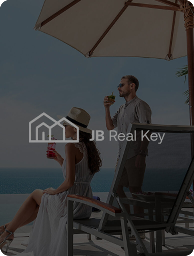 Couple enjoying a sunny day at the beach and drinking