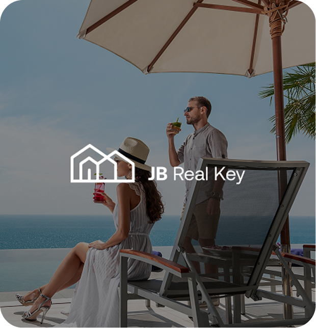 Couple enjoying a sunny day at the beach and drinking